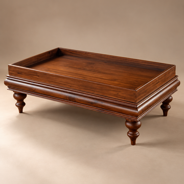 A rectangular wooden coffee table with turned legs and a raised tray top, shown on a warm beige studio background.